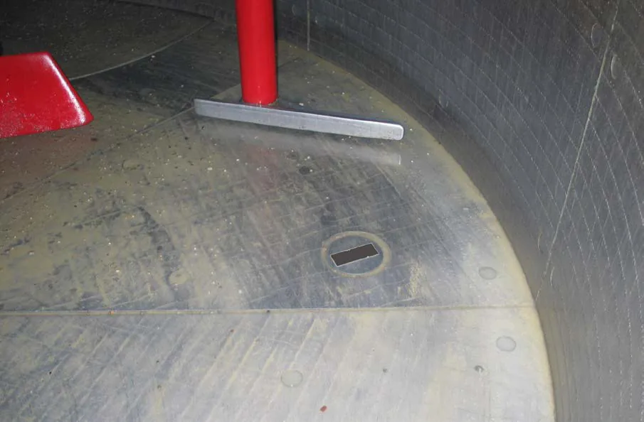 Round sensor installed through a wall, reading material at rest